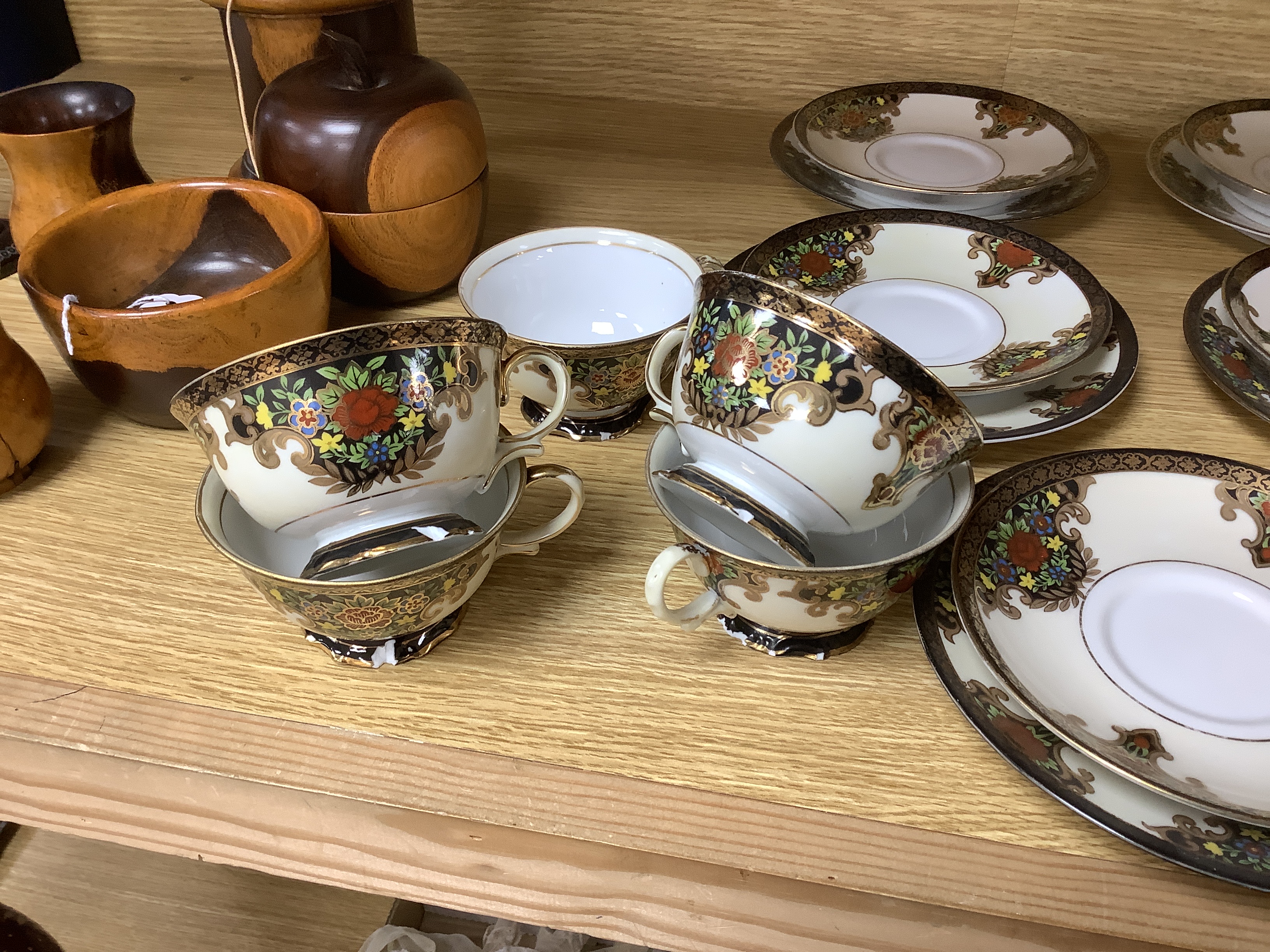 A Japanese Noritake floral and gilt tea set, comprising a sugar bowl, a milk jug, nine cups, plus saucers and tea plates